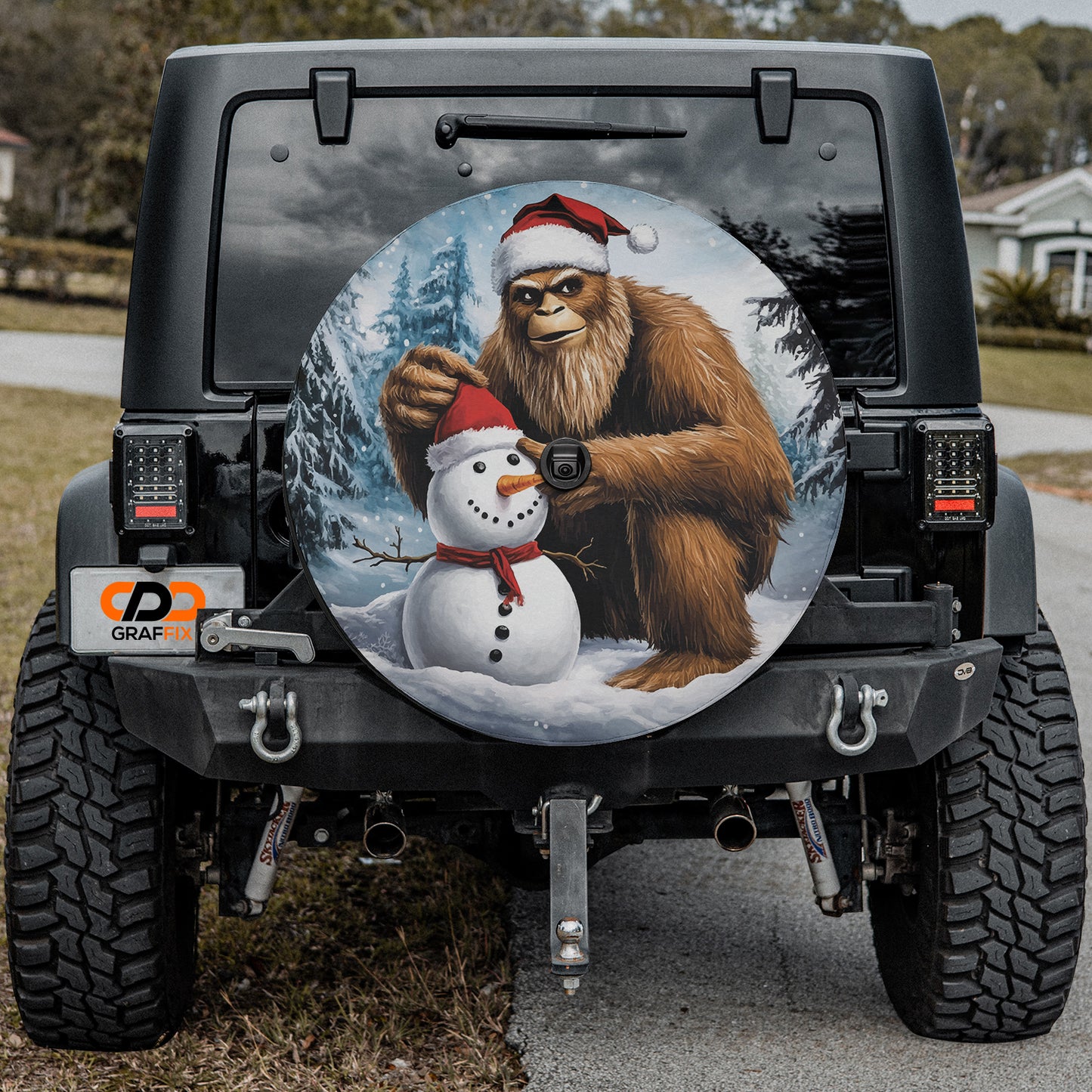 a picture of a bigfoot and a snowman on the back of a jeep