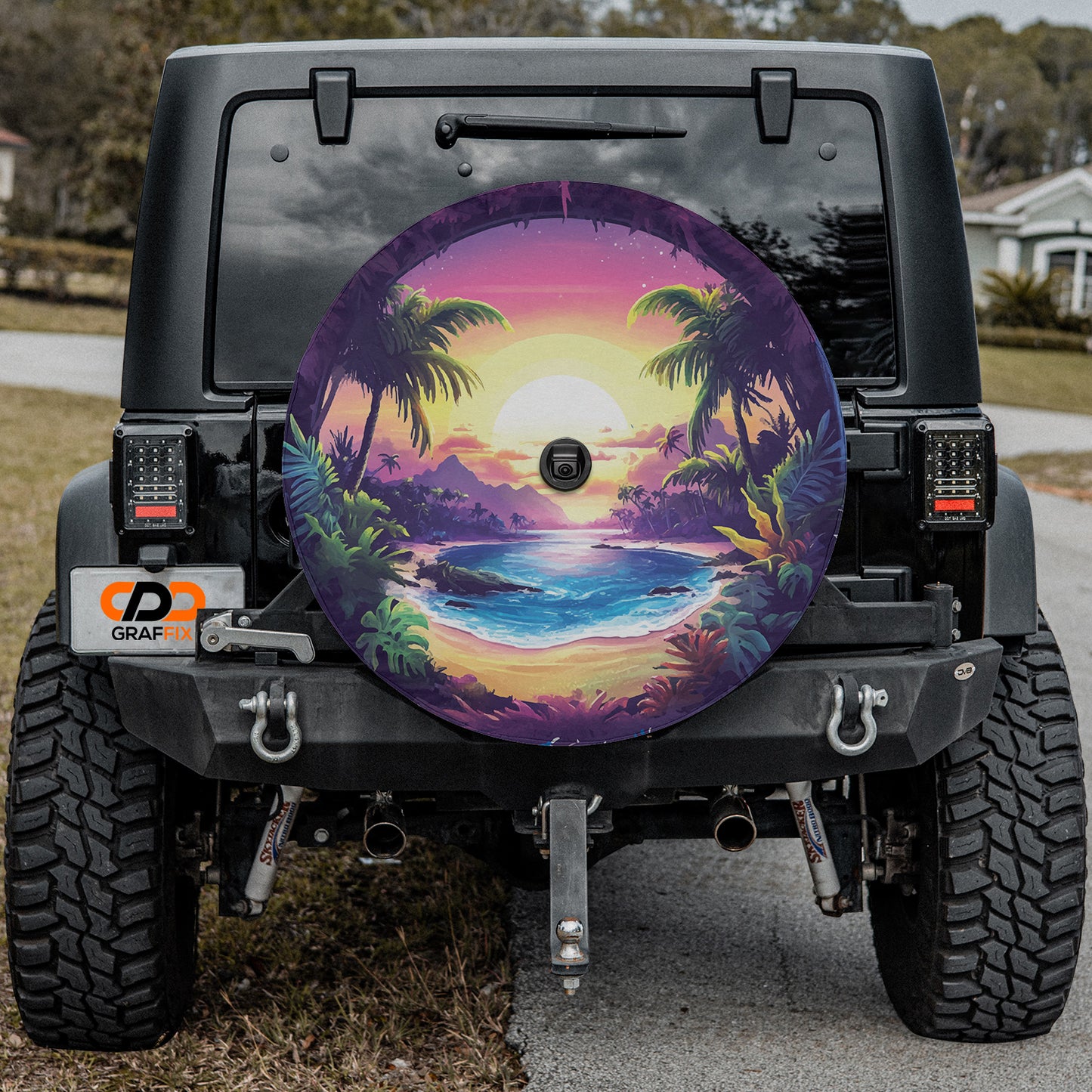 a tire cover with a painting of a tropical sunset
