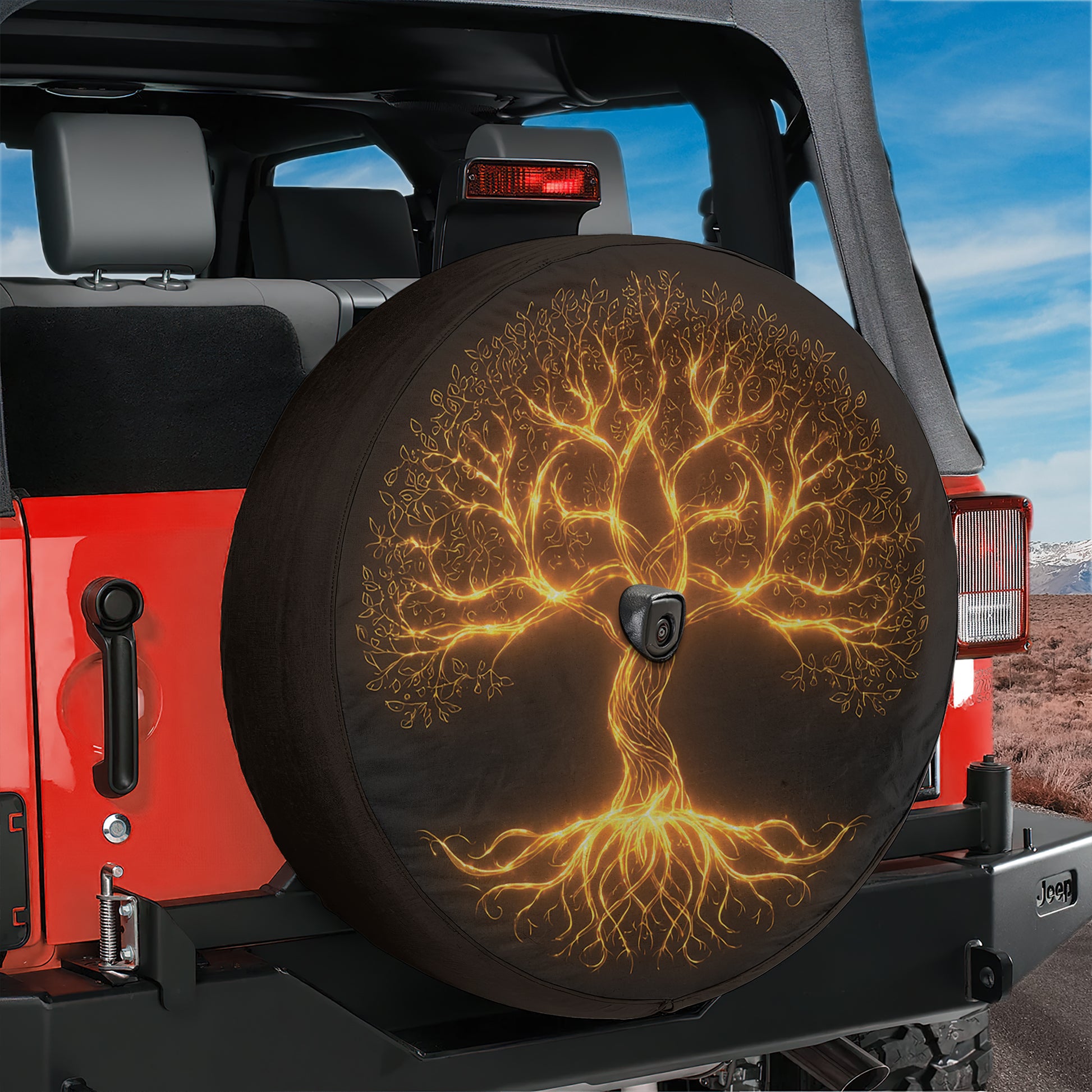 A tree-like design on a spare tire cover, featuring a golden tree with roots and branches, mounted on the rear of a red Jeep.