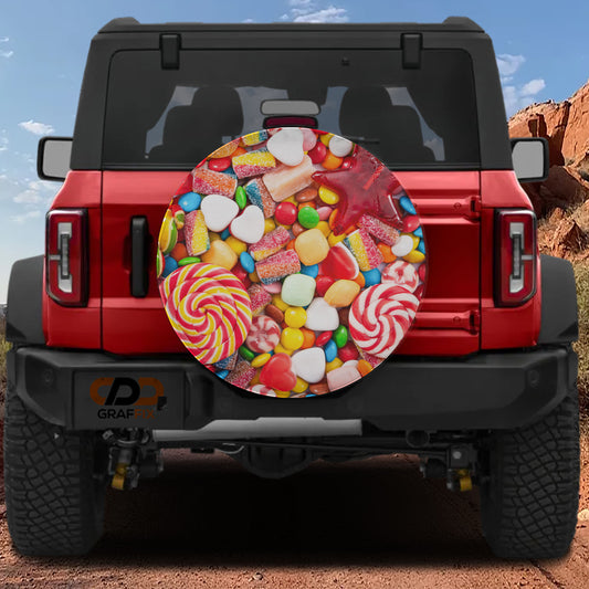 the back of a red Jeep Wrangler with a large, colorful candy-themed spare tire cover attached to it.