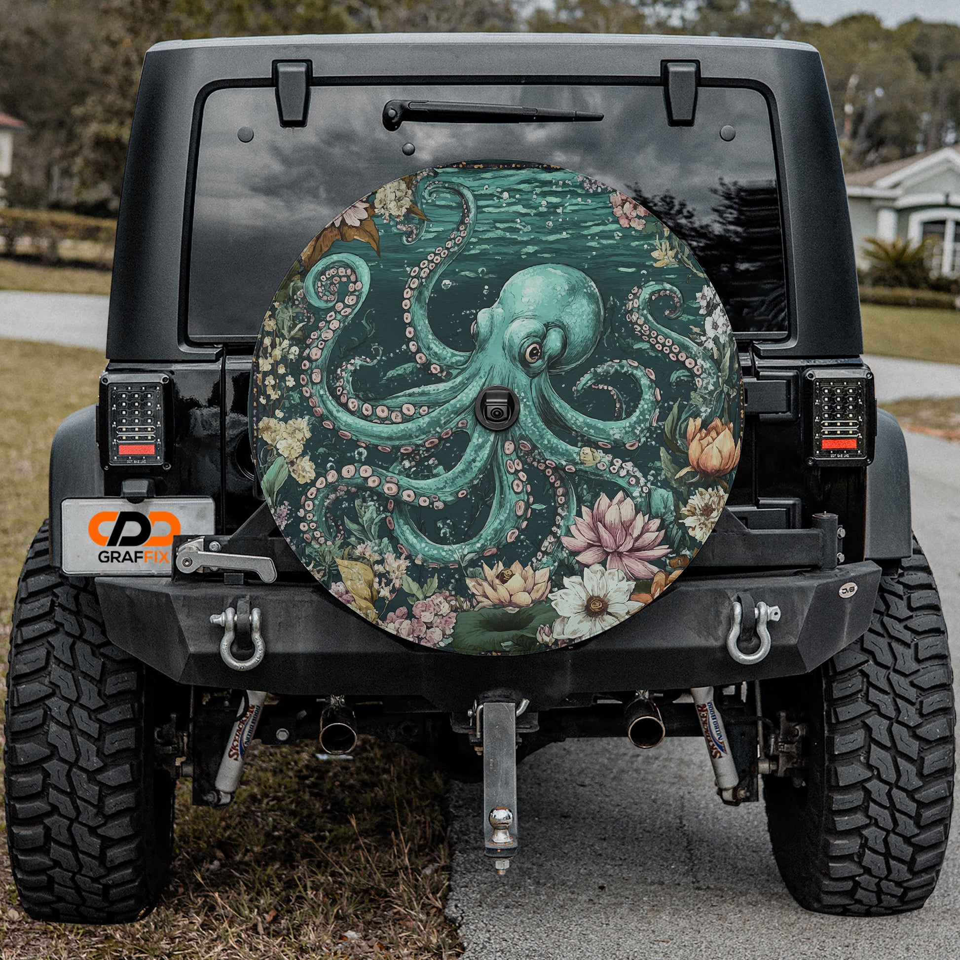 the back of a black Jeep Wrangler with a large, colorful octopus-themed spare tire attached to it.