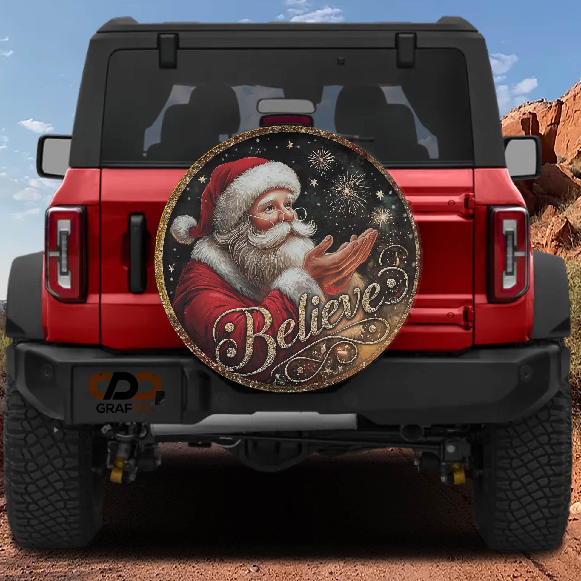 a red Jeep Wrangler with a large, decorative wheel cover featuring a picture of Santa Claus and the word "Believe" written on it.