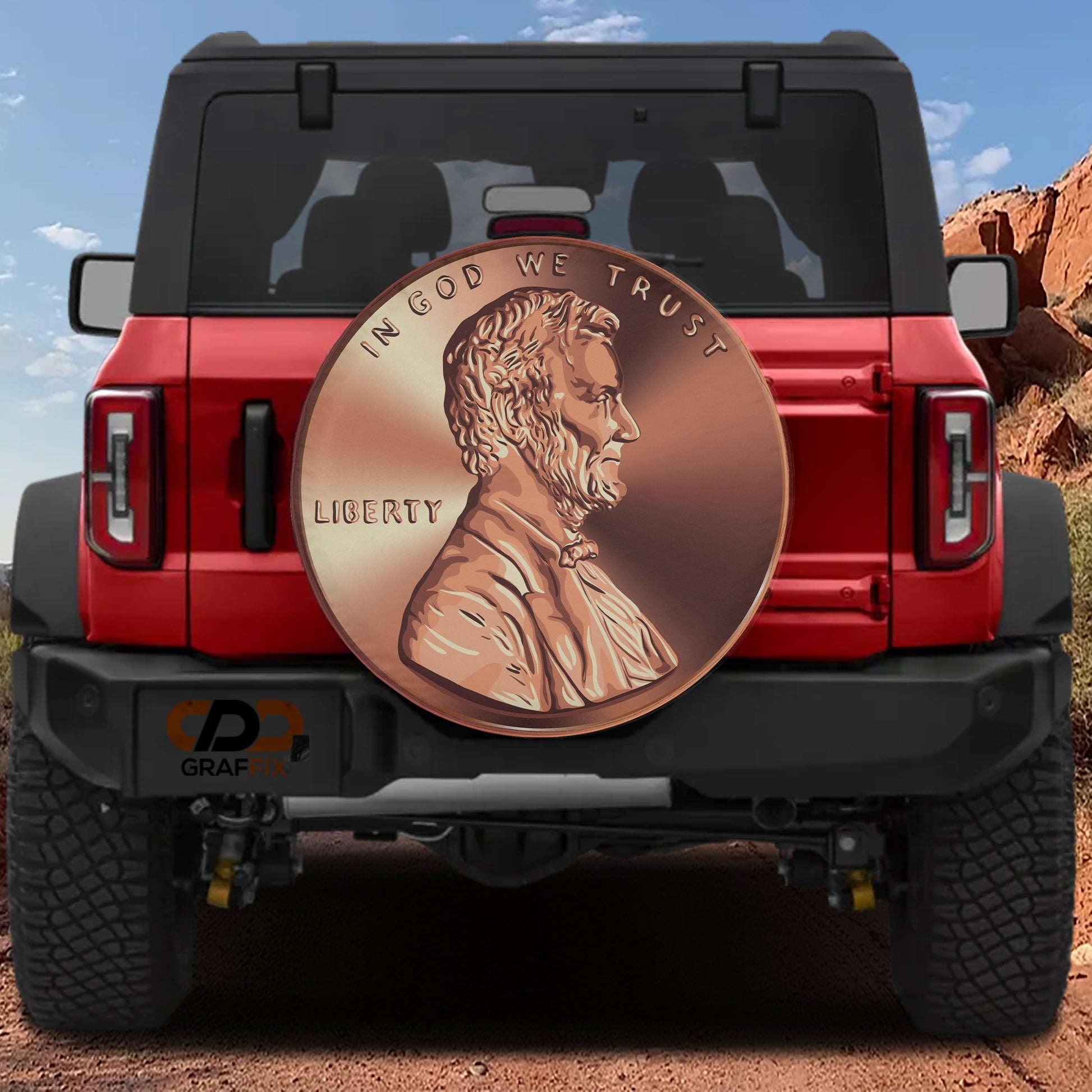 a red Jeep Wrangler with a large, detailed copper-colored Lincoln penny displayed on the rear window.