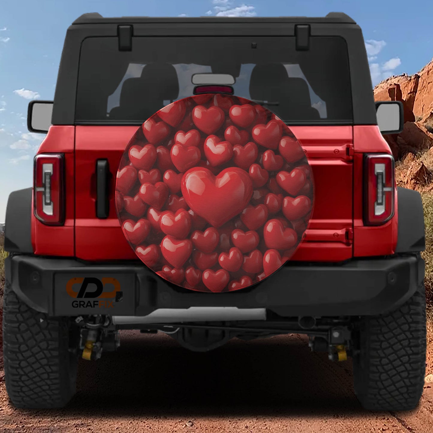 the back of a red Jeep Wrangler with a heart-shaped spare tire cover attached to it.
