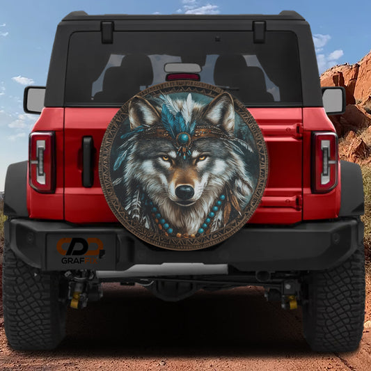 A red Jeep Wrangler with a large tribal-style wheel cover featuring a wolf's face and feathers.