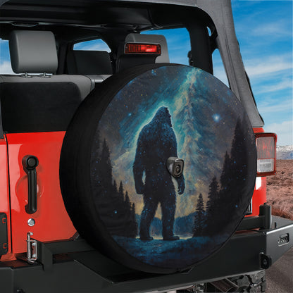 A large tire cover with a picture of a giant Sasquatch or Sasquatch-like creature against a night sky background.