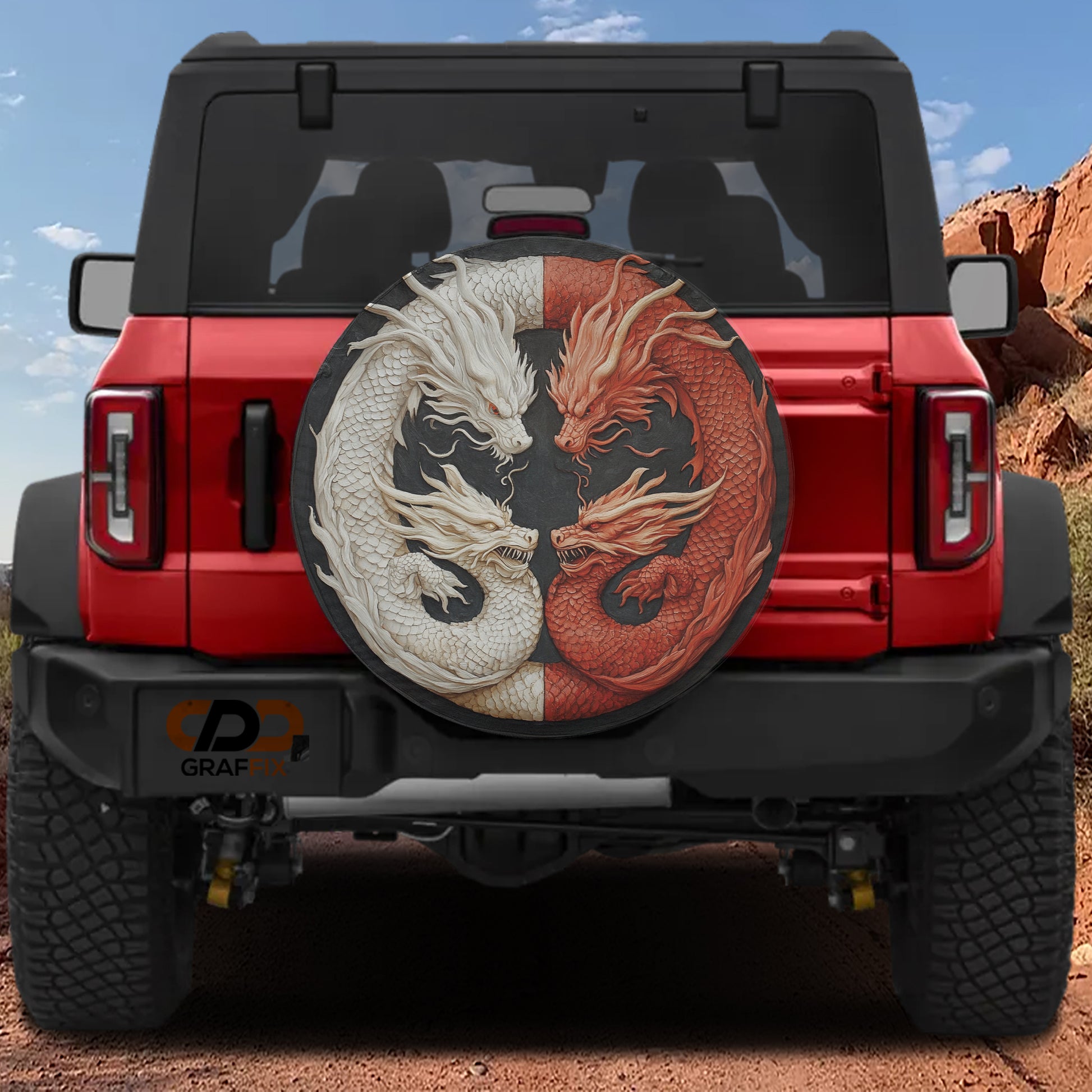 A red Jeep Wrangler with a large, decorative dragon-themed spare tire attached to the rear.