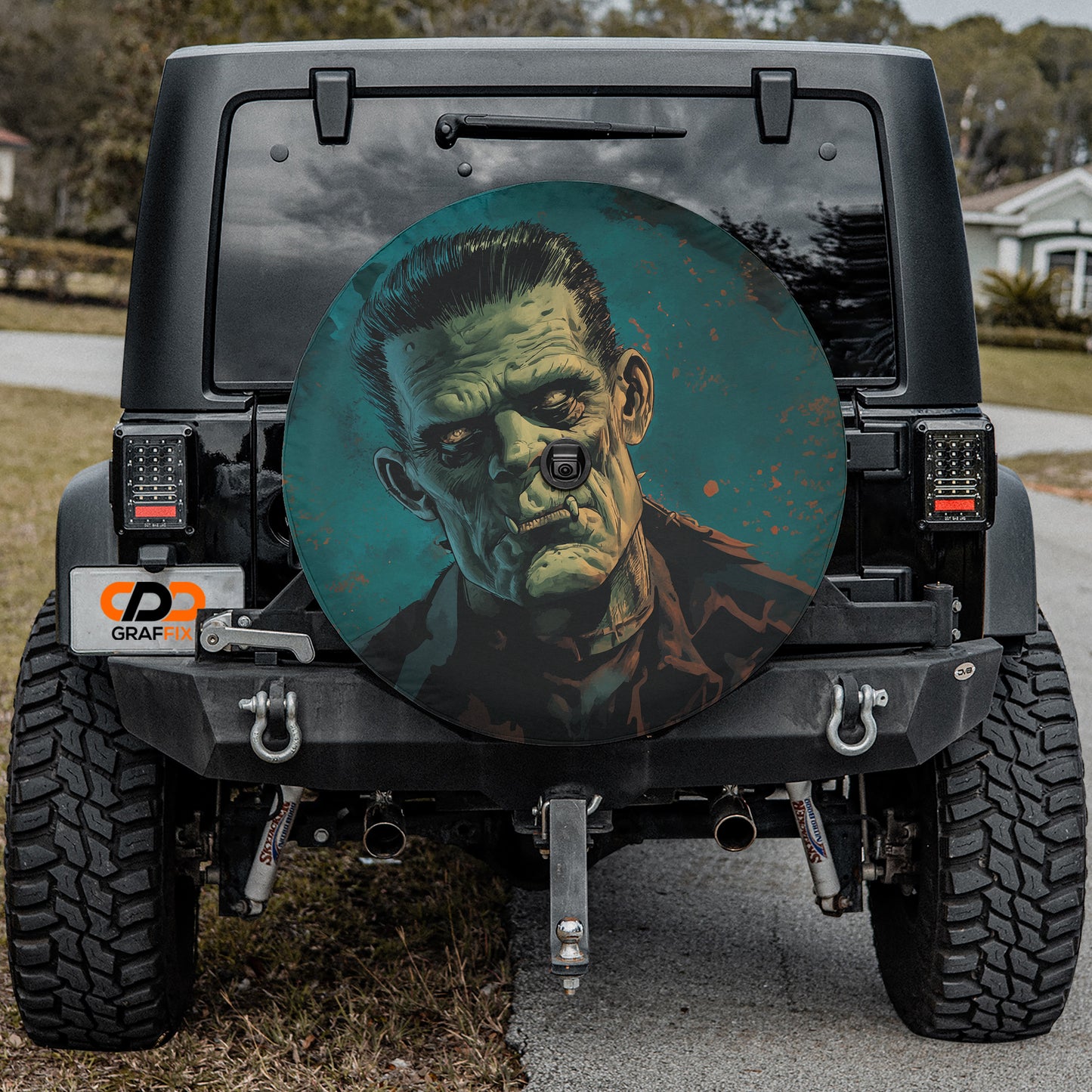 a large, round, and colorful wheel cover depicting a man with a creepy, unsettling expression.