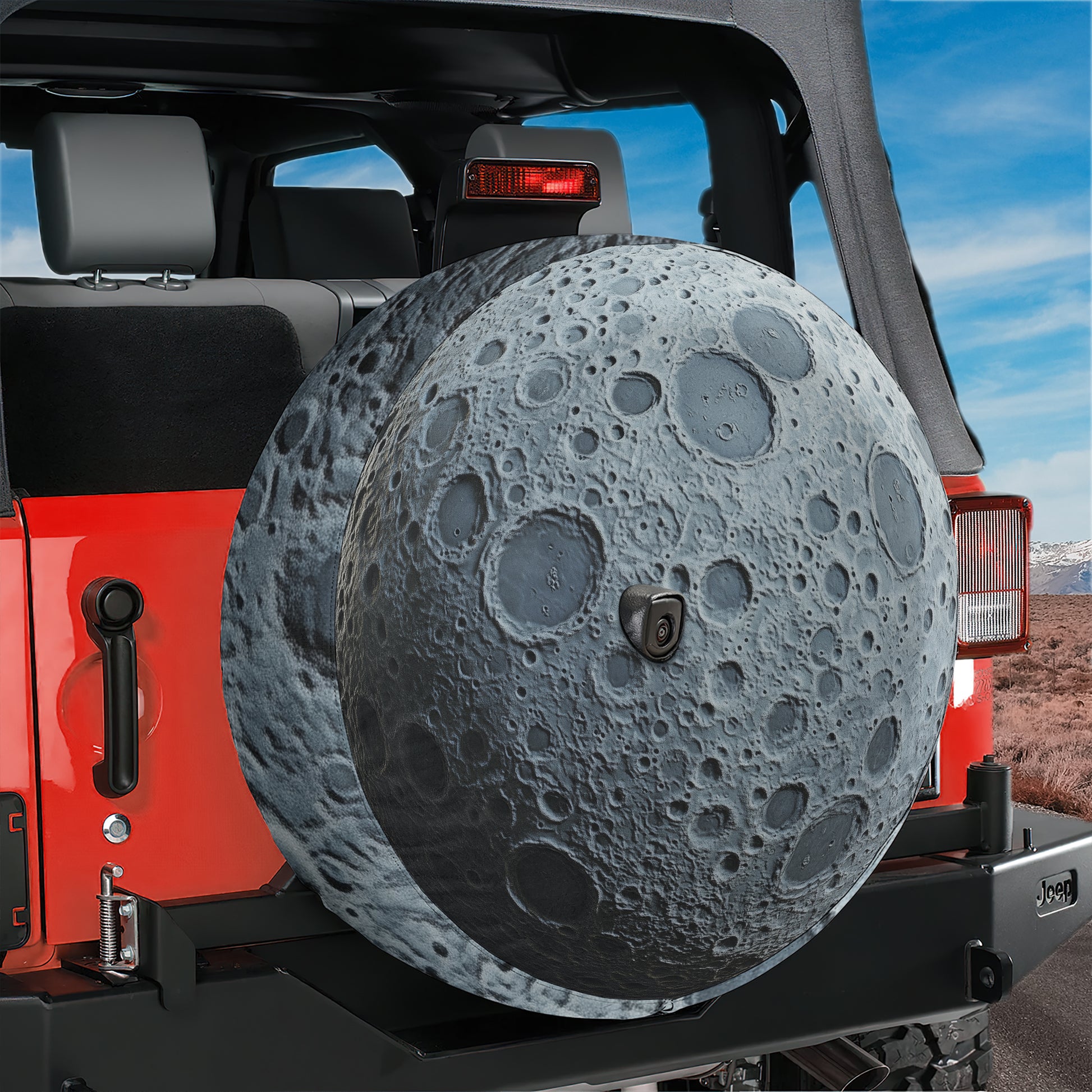 A red Jeep Wrangler with a large, moon-shaped spare tire attached to the rear.
