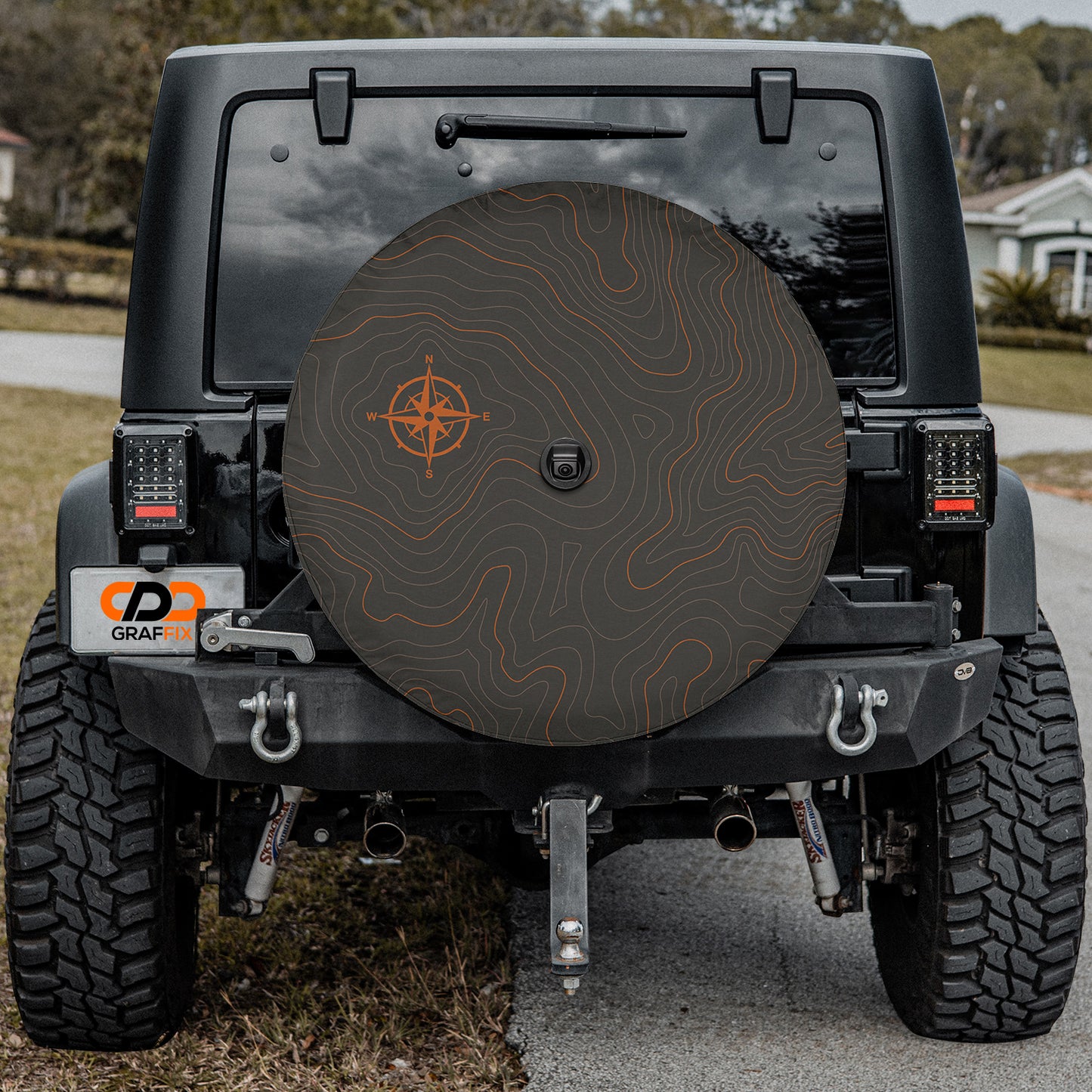 a black jeep with a black tire cover on it