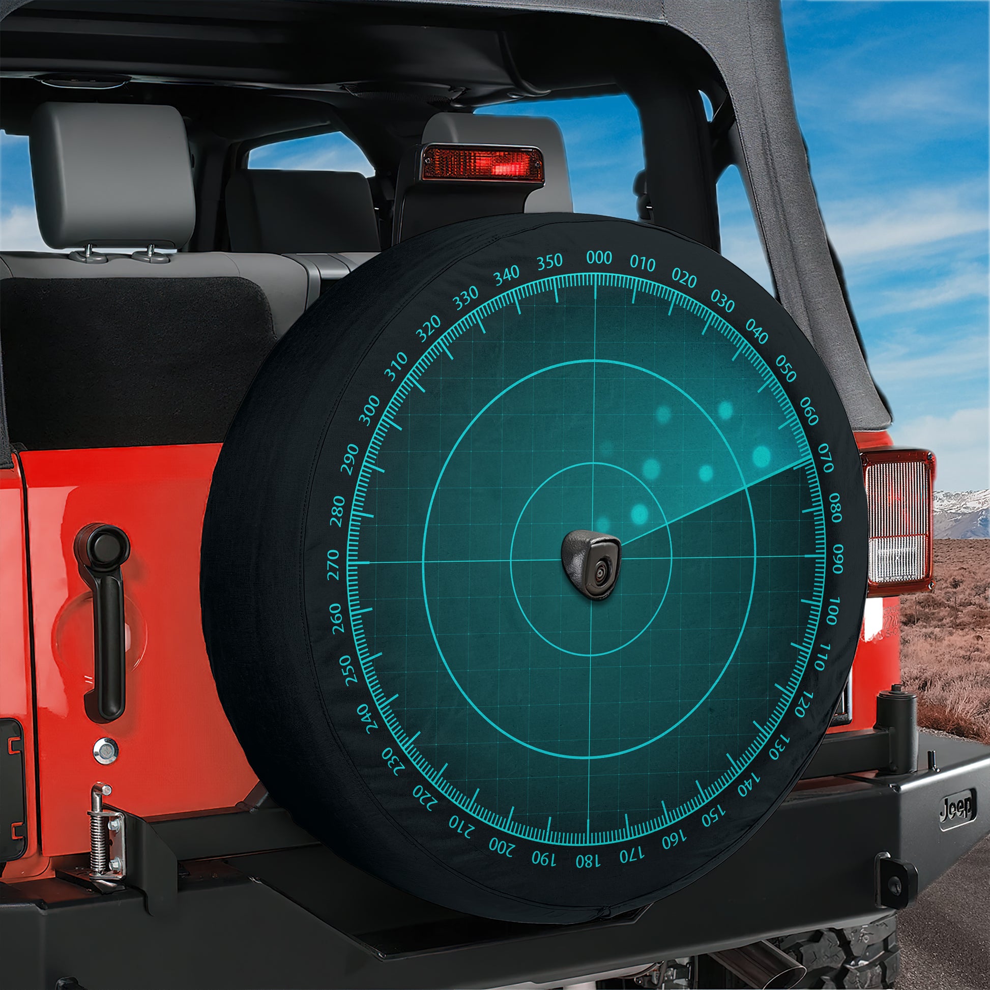 A red Jeep Wrangler with a large spare tire mounted on the rear of the vehicle.