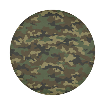 A circular image with a camouflage pattern, featuring various shades of green, brown, and black.