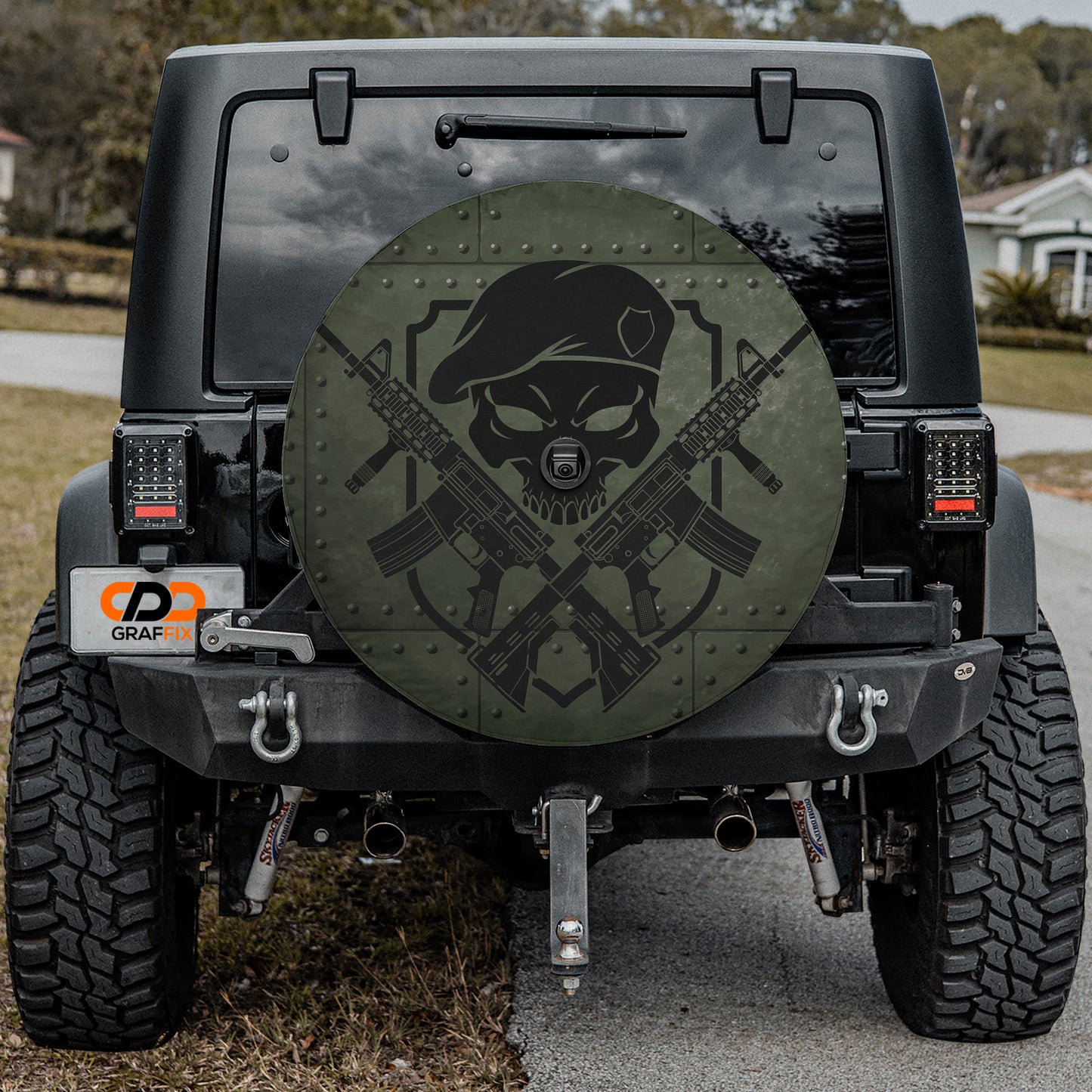 the back of a black Jeep Wrangler with a large, round, military-style decal on the rear window.