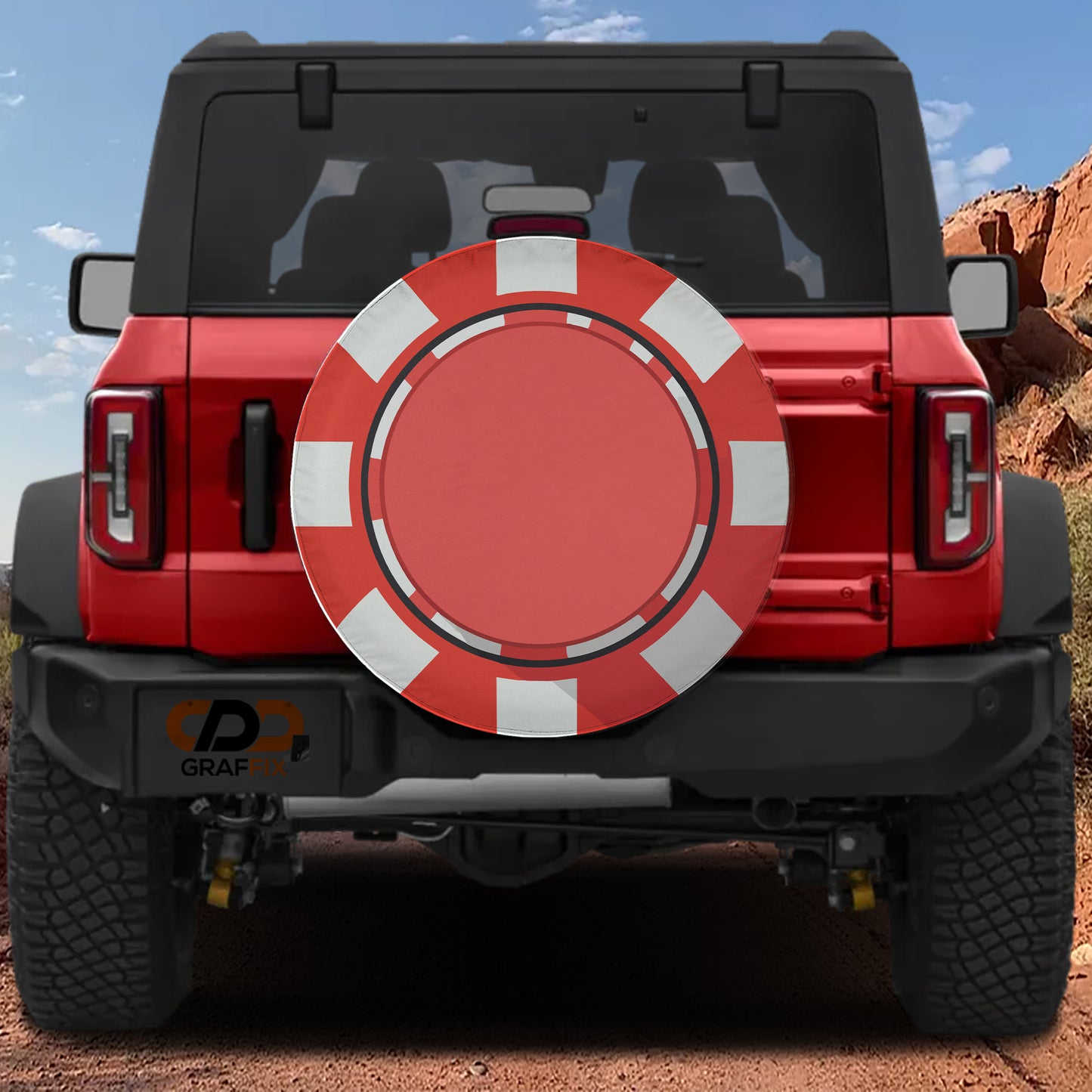 A red Jeep Wrangler with a large red and white tire cover attached to the rear of the vehicle.