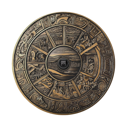 a circular metal object with a picture of a landscape