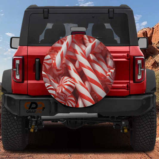 the back of a red Jeep Wrangler with a large candy-themed spare tire cover attached to it.