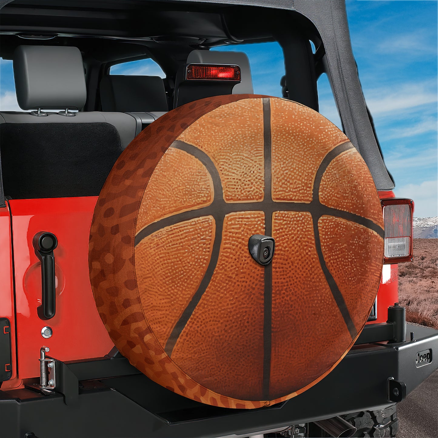 A red Jeep with a basketball-themed spare tire mounted on the rear of the vehicle.