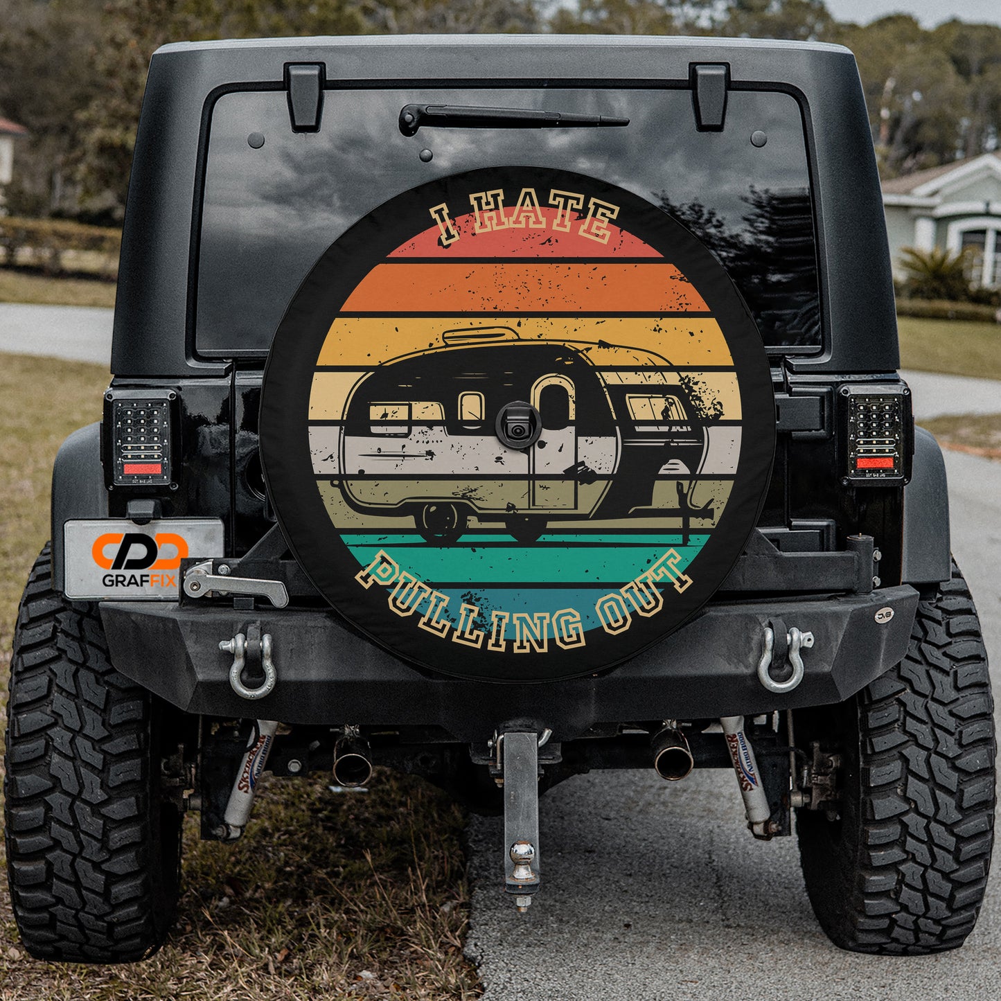 the back of a black Jeep Wrangler with a colorful wheel cover featuring a camper van design.