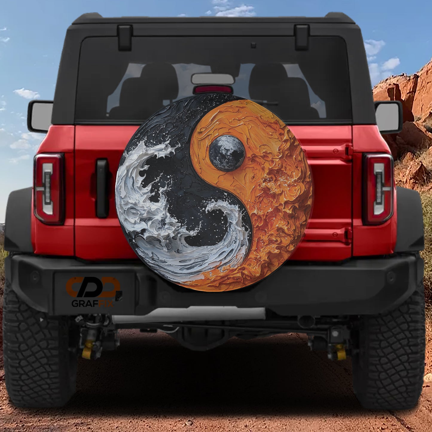 A red Jeep Wrangler with a large, circular spare tire attached to the rear. The spare tire features a yin and yang symbol, which is a popular design element in automotive art and decoration.