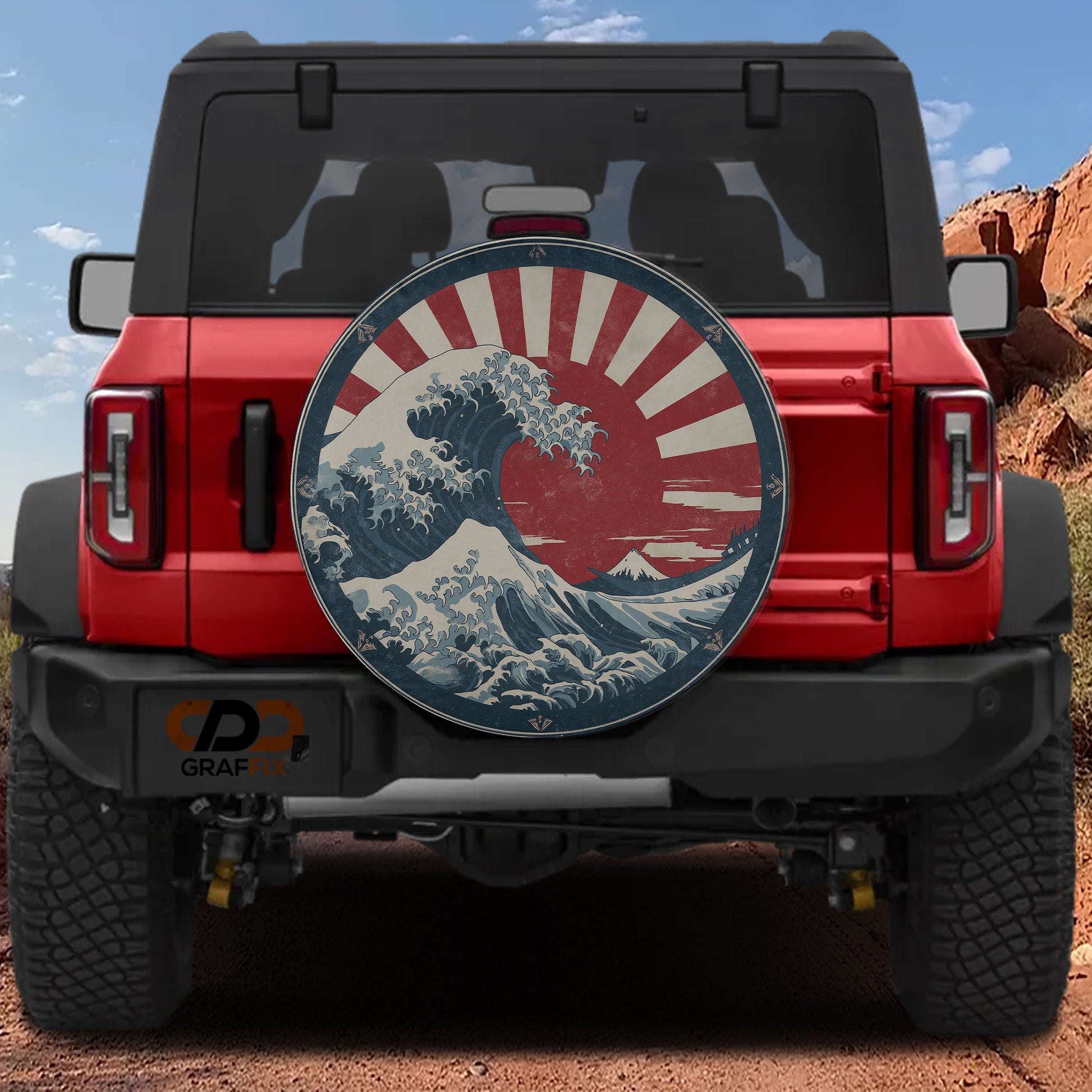 A red Jeep Wrangler with a large Japanese wave decal on the rear window.