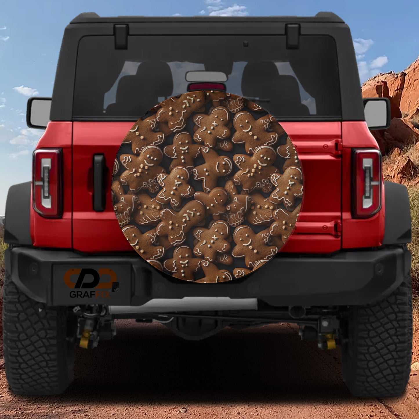 a red Jeep Wrangler with a gingerbread man-themed spare tire cover attached to the rear of the vehicle.