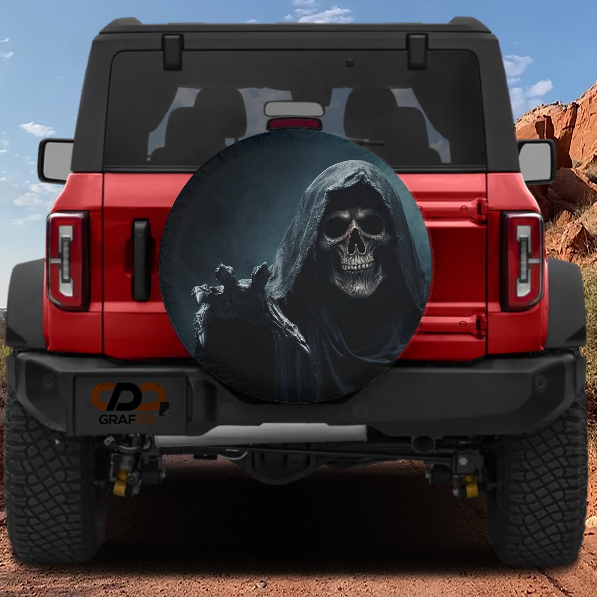 a red Jeep Wrangler with a skull-themed spare tire cover on the rear.