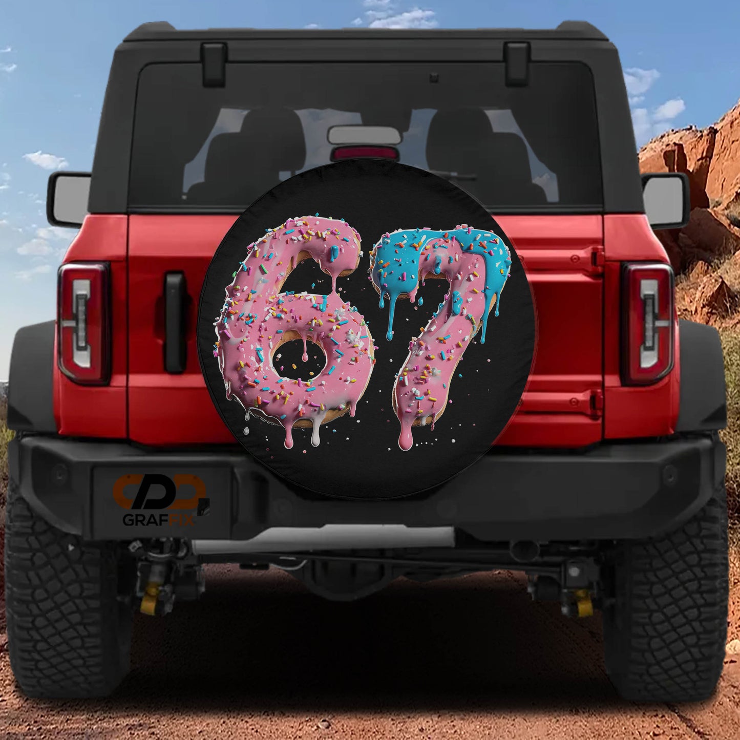 A red Jeep Wrangler with a large tire cover featuring the number "67" in pink and blue frosting.