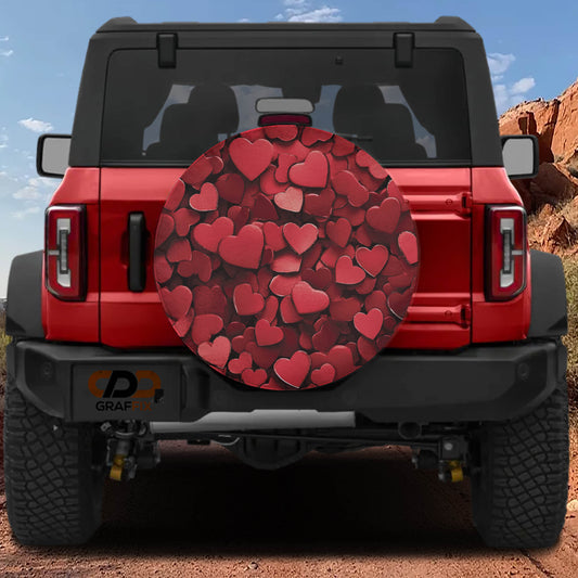a red Jeep Wrangler with a heart-shaped spare tire cover attached to it.