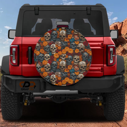 a red Jeep Wrangler with a large round spare tire cover that has a skull and flower design on it.