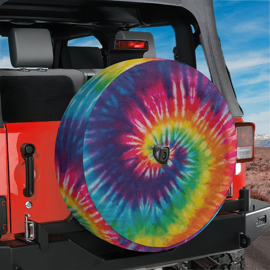 a colorful tie - dyed tire cover on a jeep