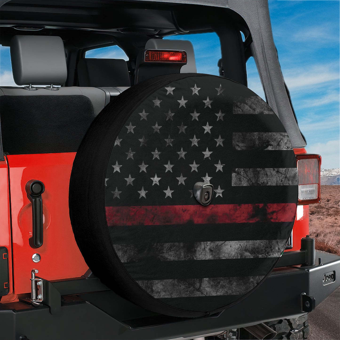 a red Jeep Wrangler with a black and red American flag decal on the rear tire cover.