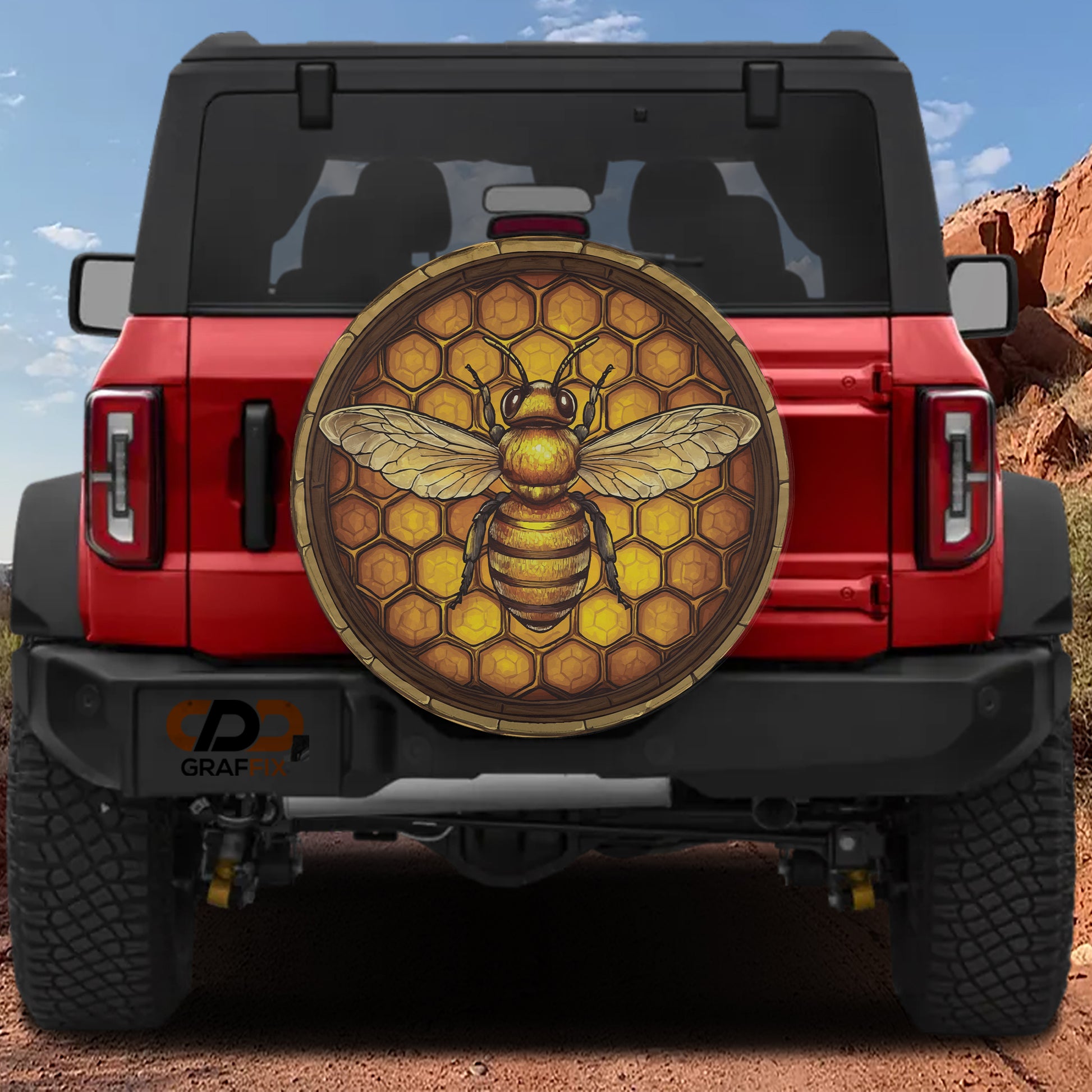 A red Jeep Wrangler with a large honeycomb-patterned decal on the rear window.