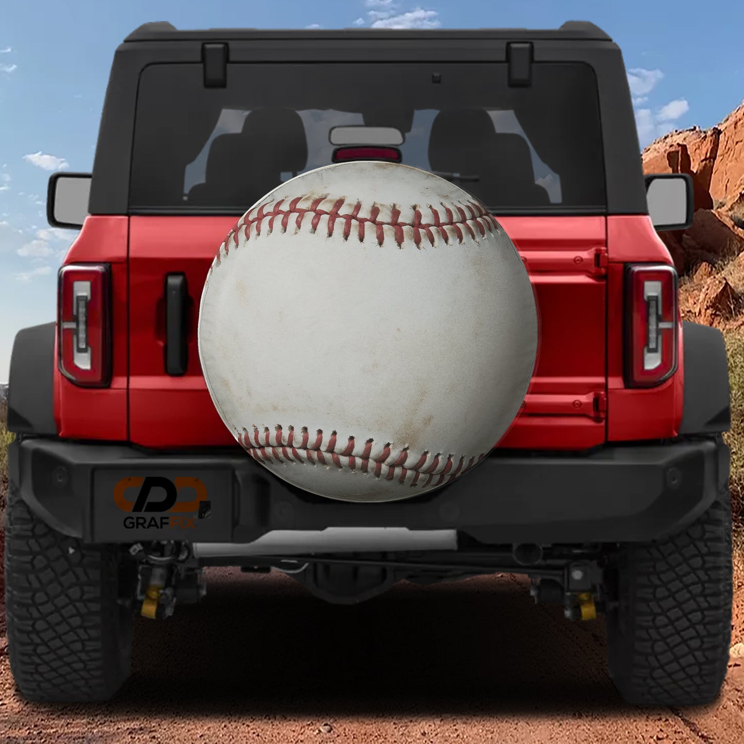 a red Jeep Wrangler with a baseball-themed spare tire cover attached to the rear of the vehicle.