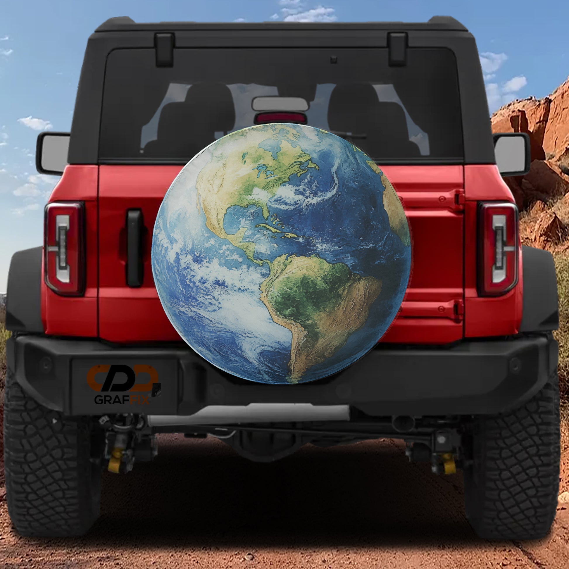 a red Jeep Wrangler with a large globe-shaped spare tire attached to the rear of the vehicle.