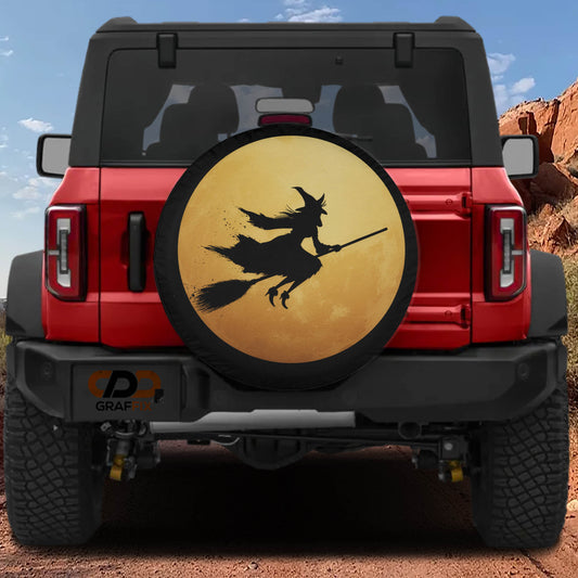 a red Jeep Wrangler with a large tire cover depicting a witch on a broomstick.