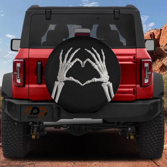 A red Jeep Wrangler with a skeleton handprint on the spare tire cover.