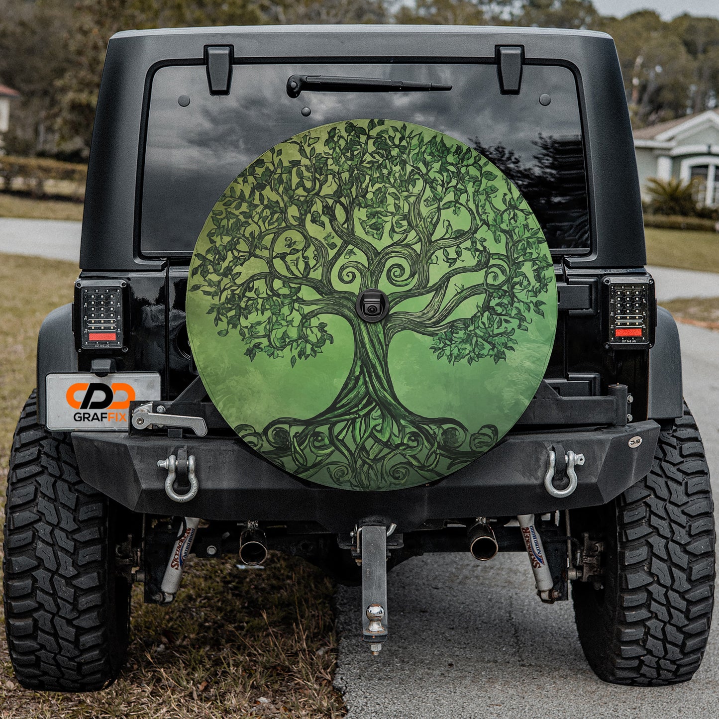 the back of a black Jeep Wrangler with a large tree-like design on the rear window.