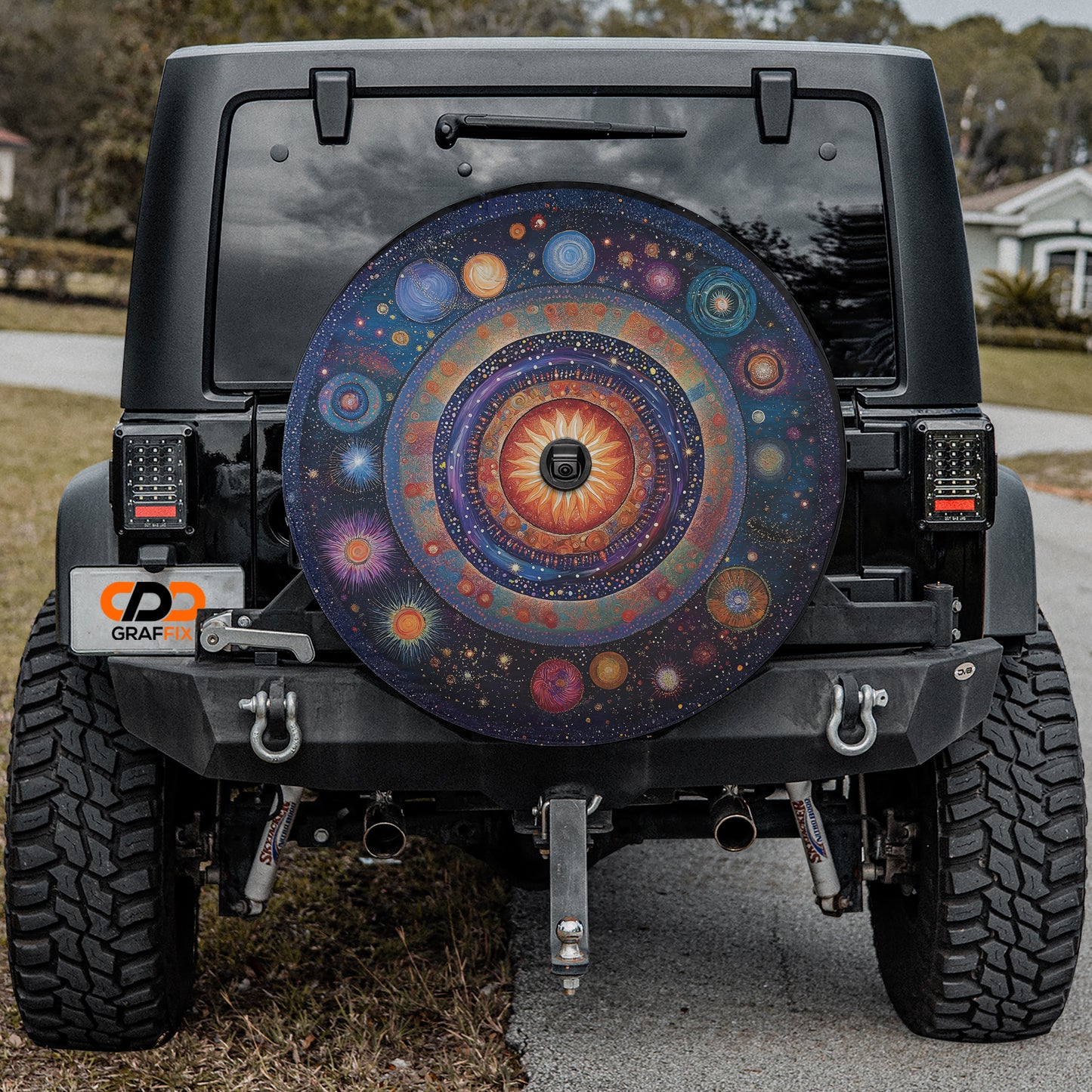 the rear of a black Jeep Wrangler with a colorful, circular spare tire cover attached to it.