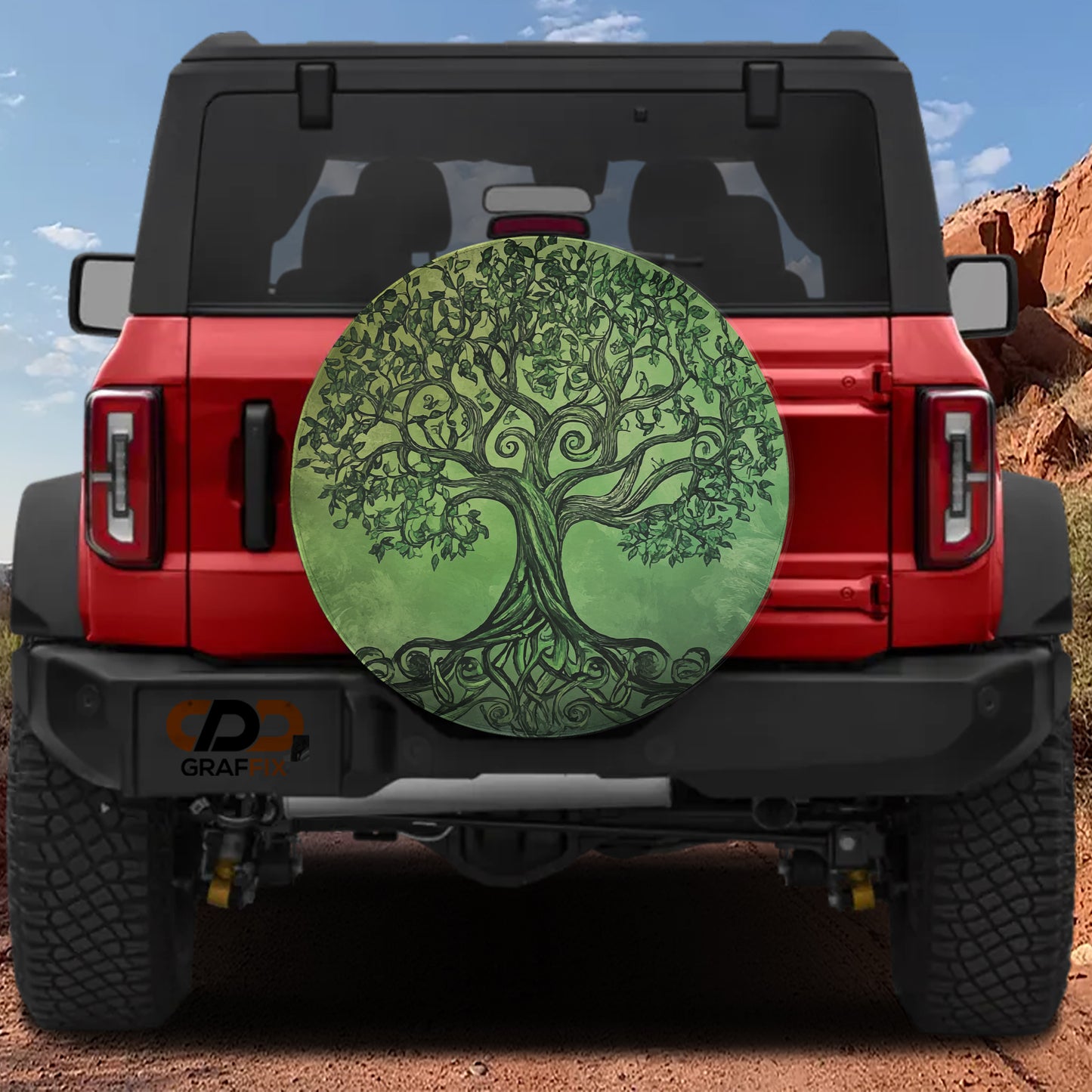 the back of a red Jeep Wrangler with a large tree-like design on the spare tire cover.