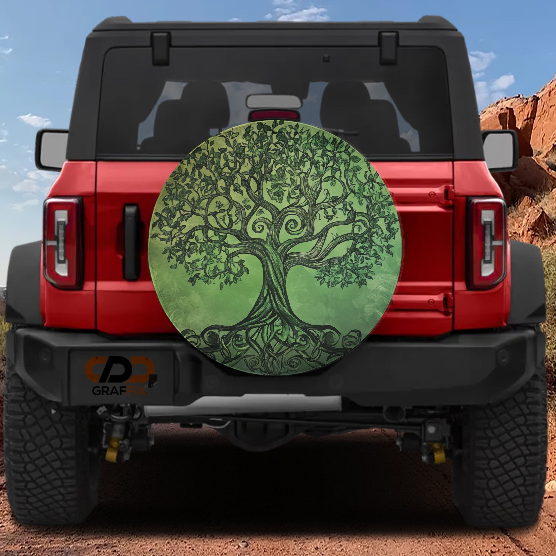 the back of a red Jeep Wrangler with a large tree-like design on the spare tire cover.