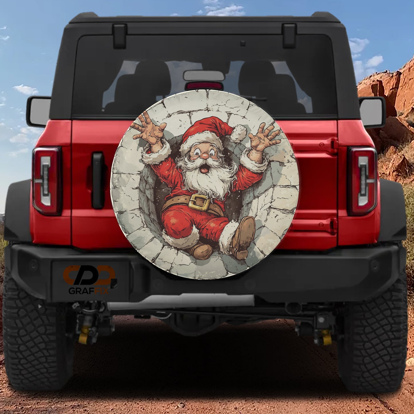 a red Jeep Wrangler with a large, round spare tire cover depicting a cartoon Santa Claus figure.