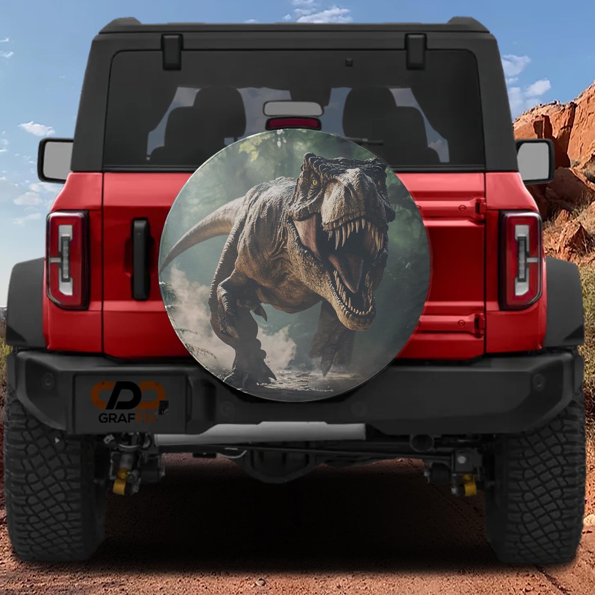 A red Jeep Wrangler with a dinosaur-themed spare tire cover on the rear.