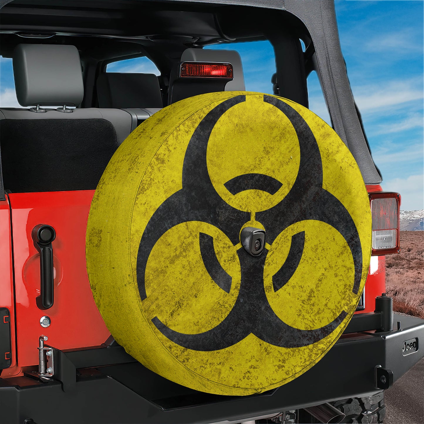 A red Jeep Wrangler with a large, yellow biohazard symbol on the rear tire cover.