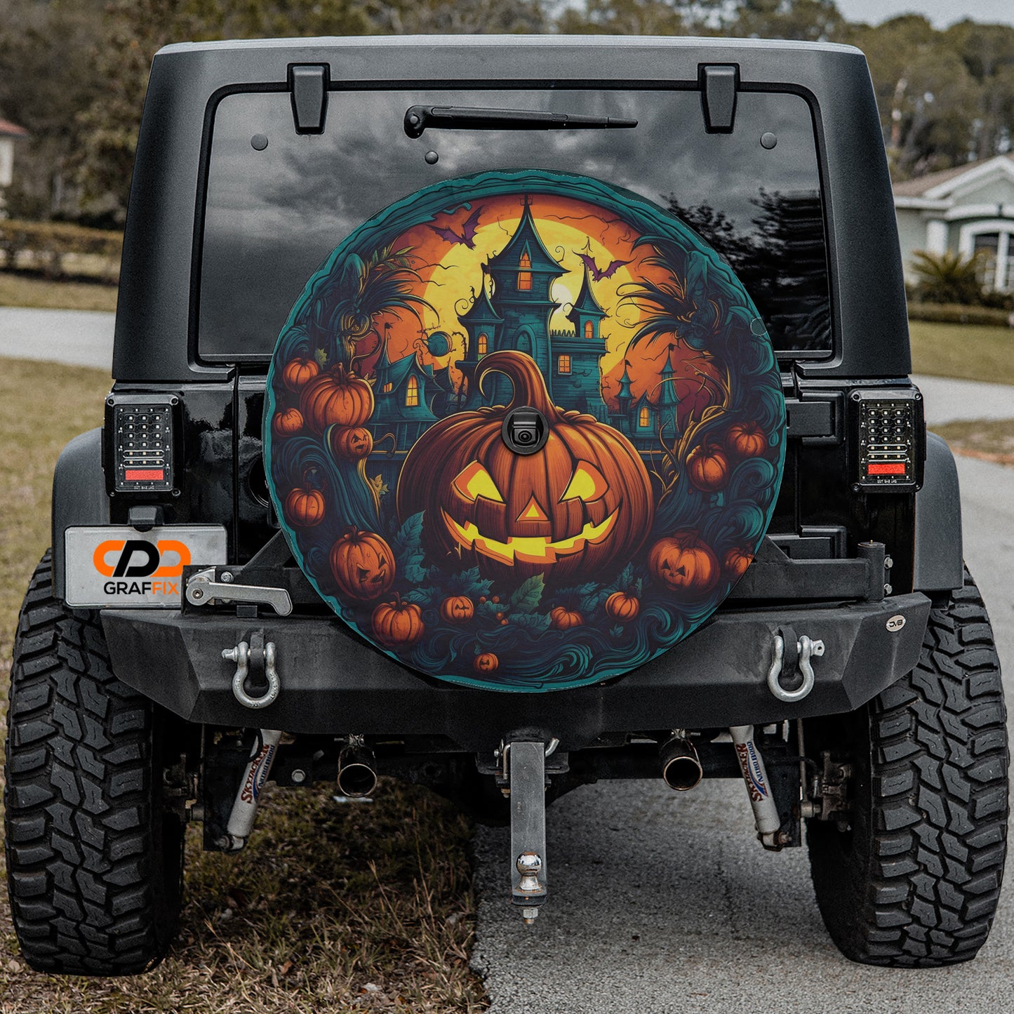 a black Jeep Wrangler with a Halloween-themed decal on the rear window.