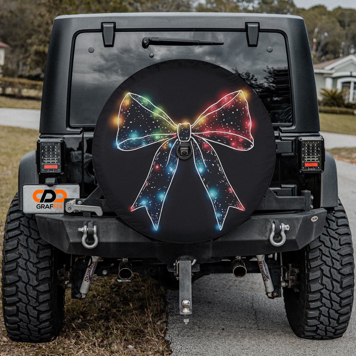a black jeep with a colorful bow on it
