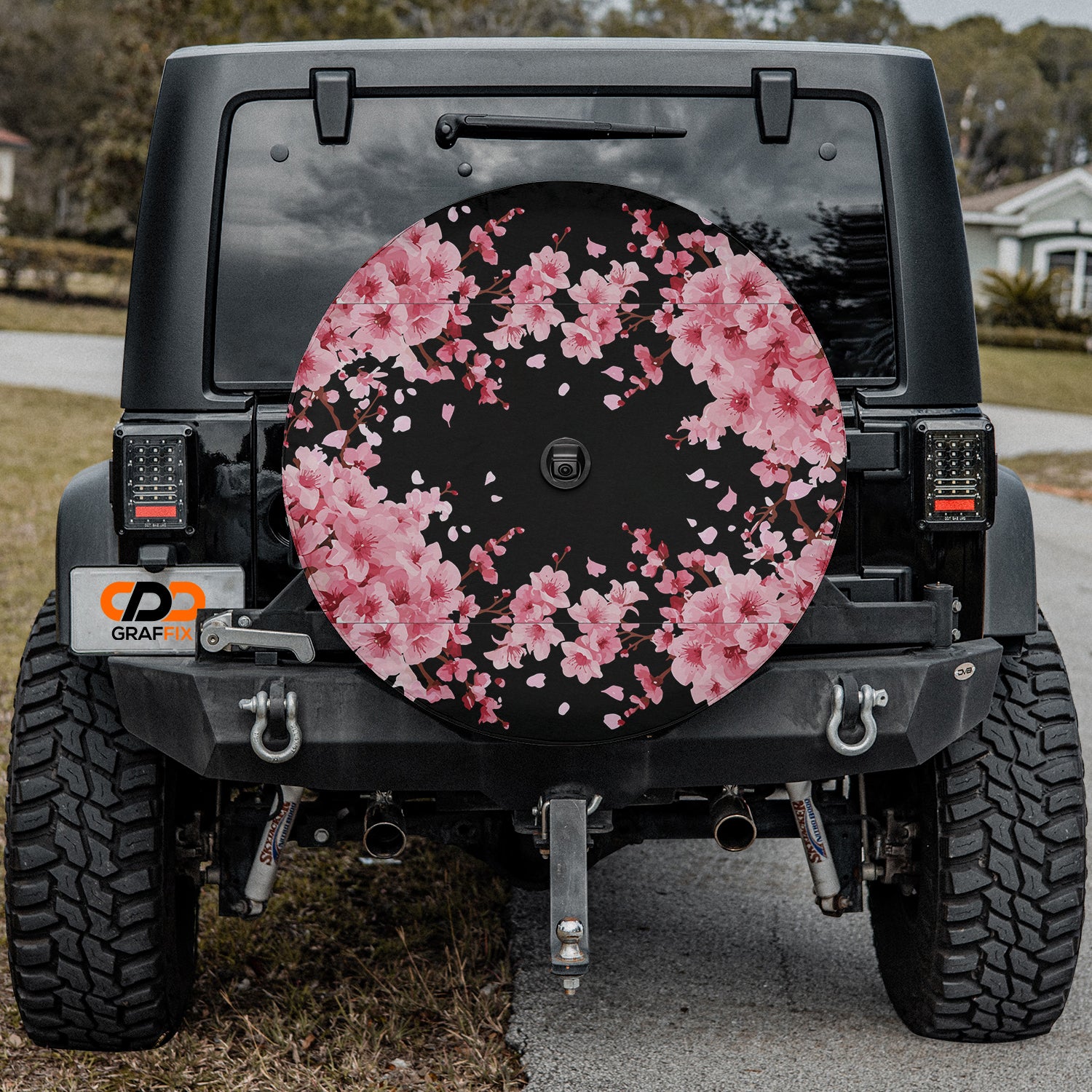 a black jeep with pink flowers painted on it