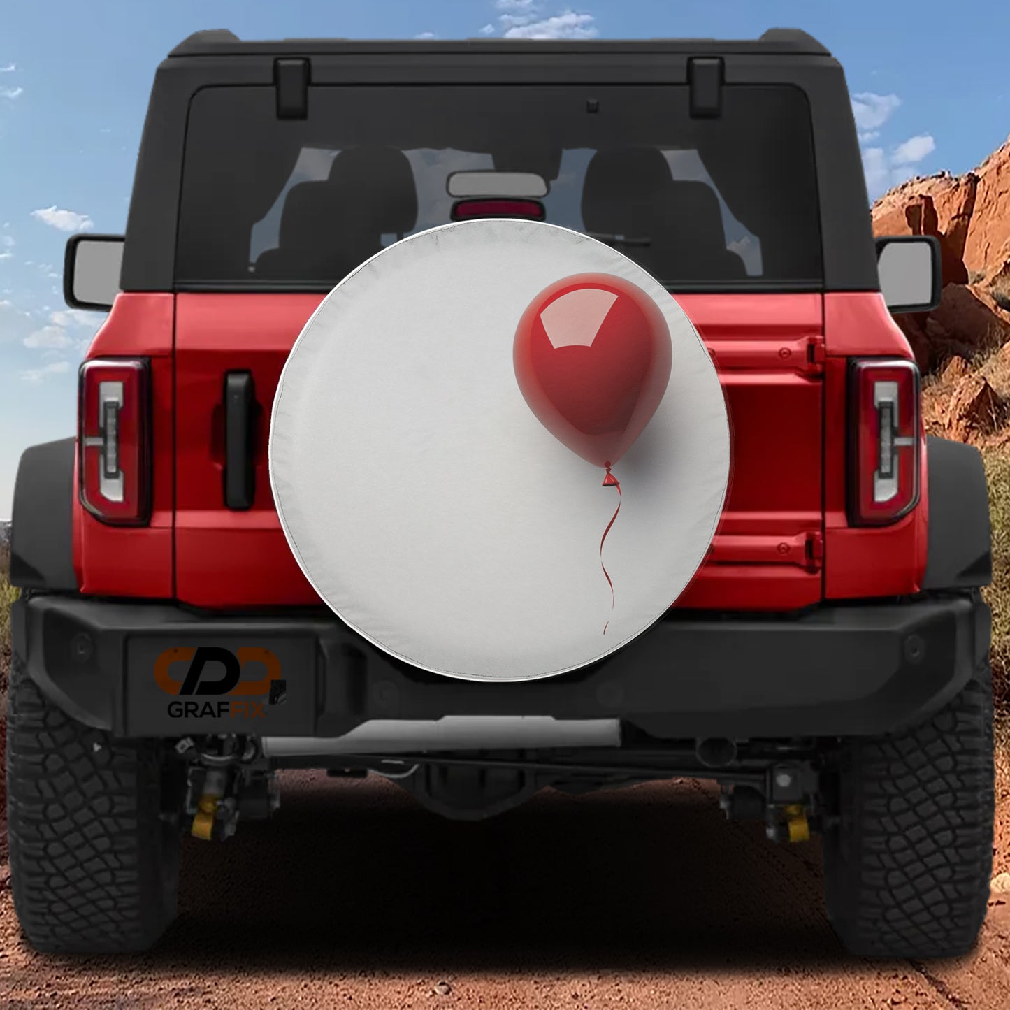 A red Jeep Wrangler with a white tire cover attached to the rear bumper, featuring a red balloon attached to the cover.