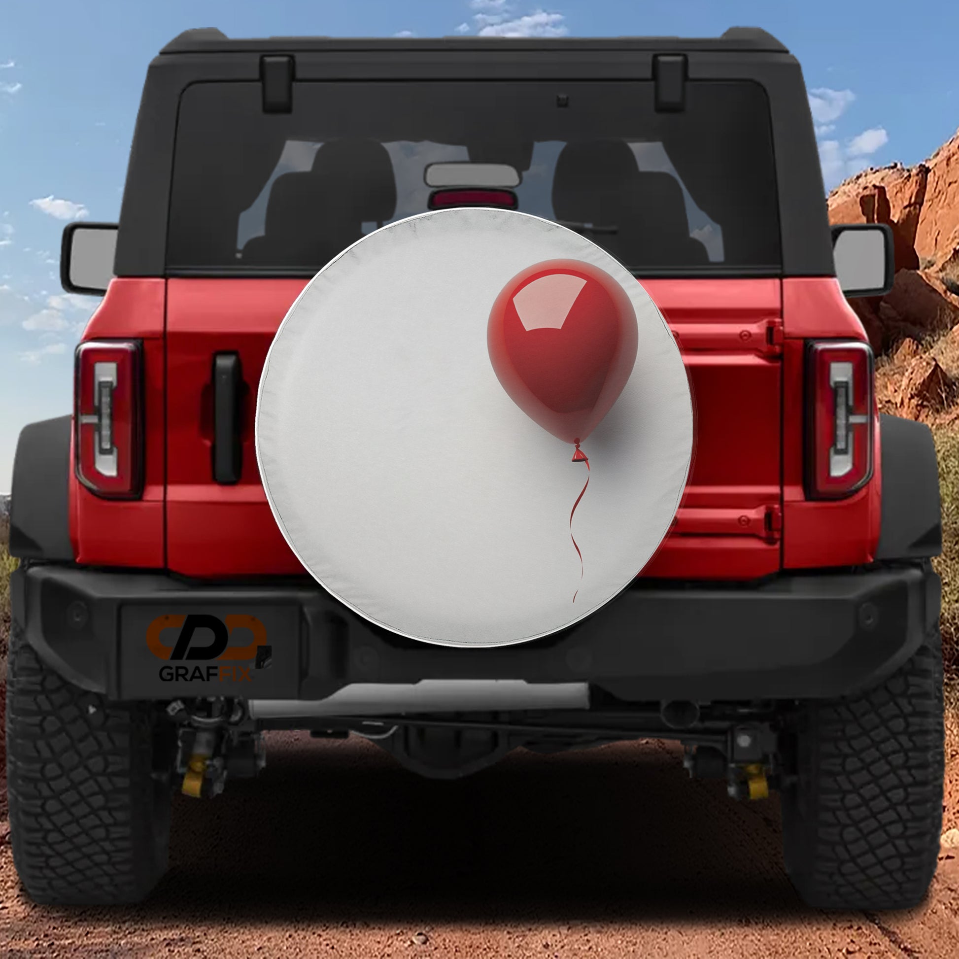 A red Jeep Wrangler with a white tire cover attached to the rear bumper, featuring a red balloon attached to the cover.