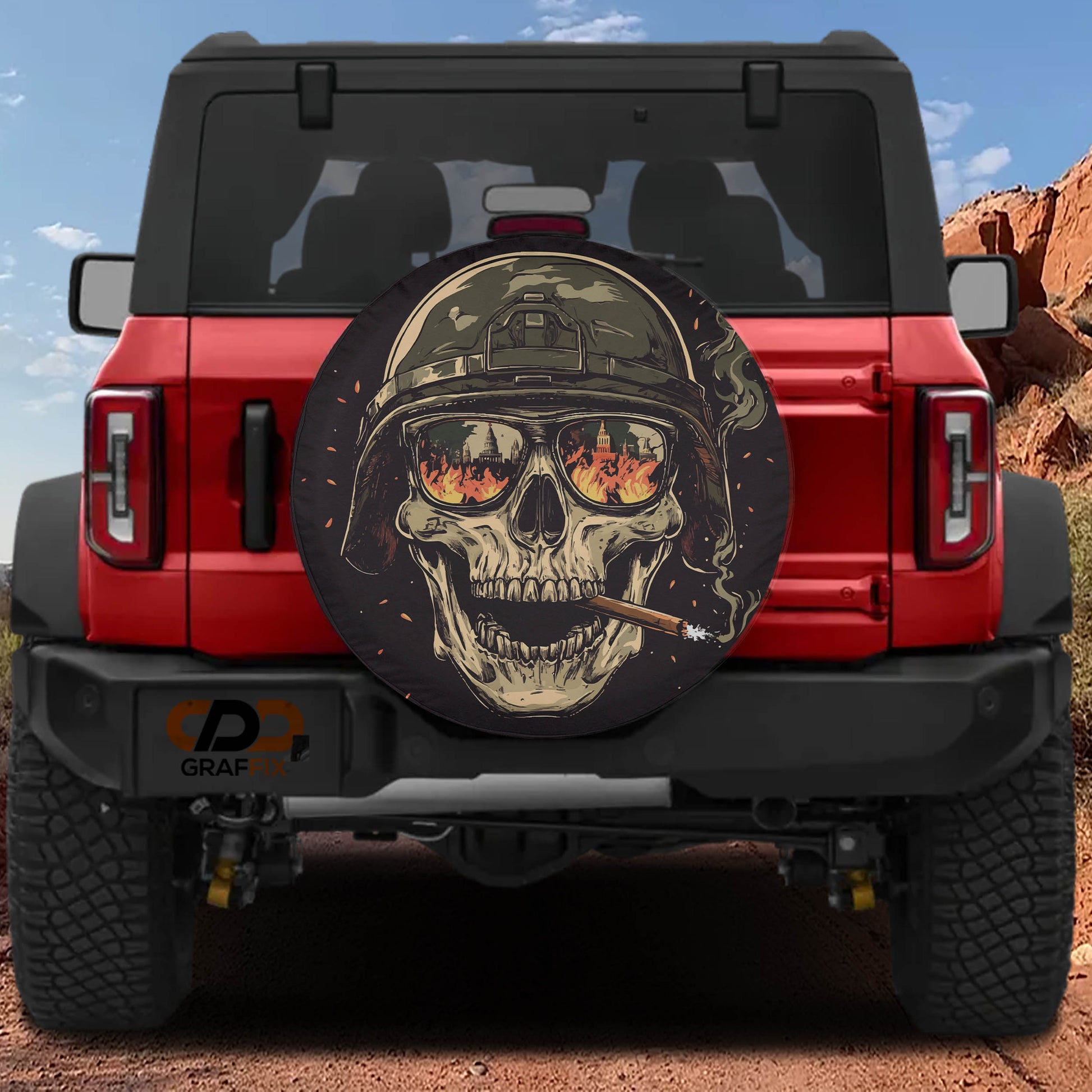 A red Jeep Wrangler with a skull-themed spare tire cover on the rear.