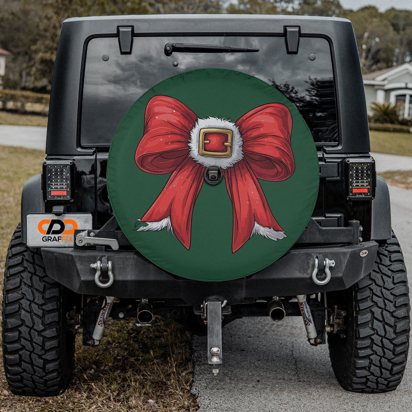 a jeep with a red bow on the front of it